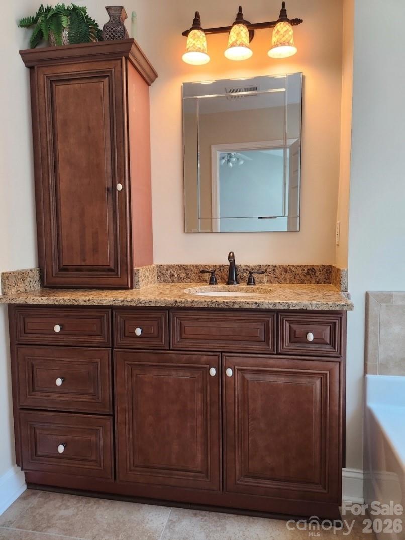 104 Rock Ridge Lane Mount Holly, NC 28120 - Photo 28 of 48 a bathroom with a sink a vanity and a mirror