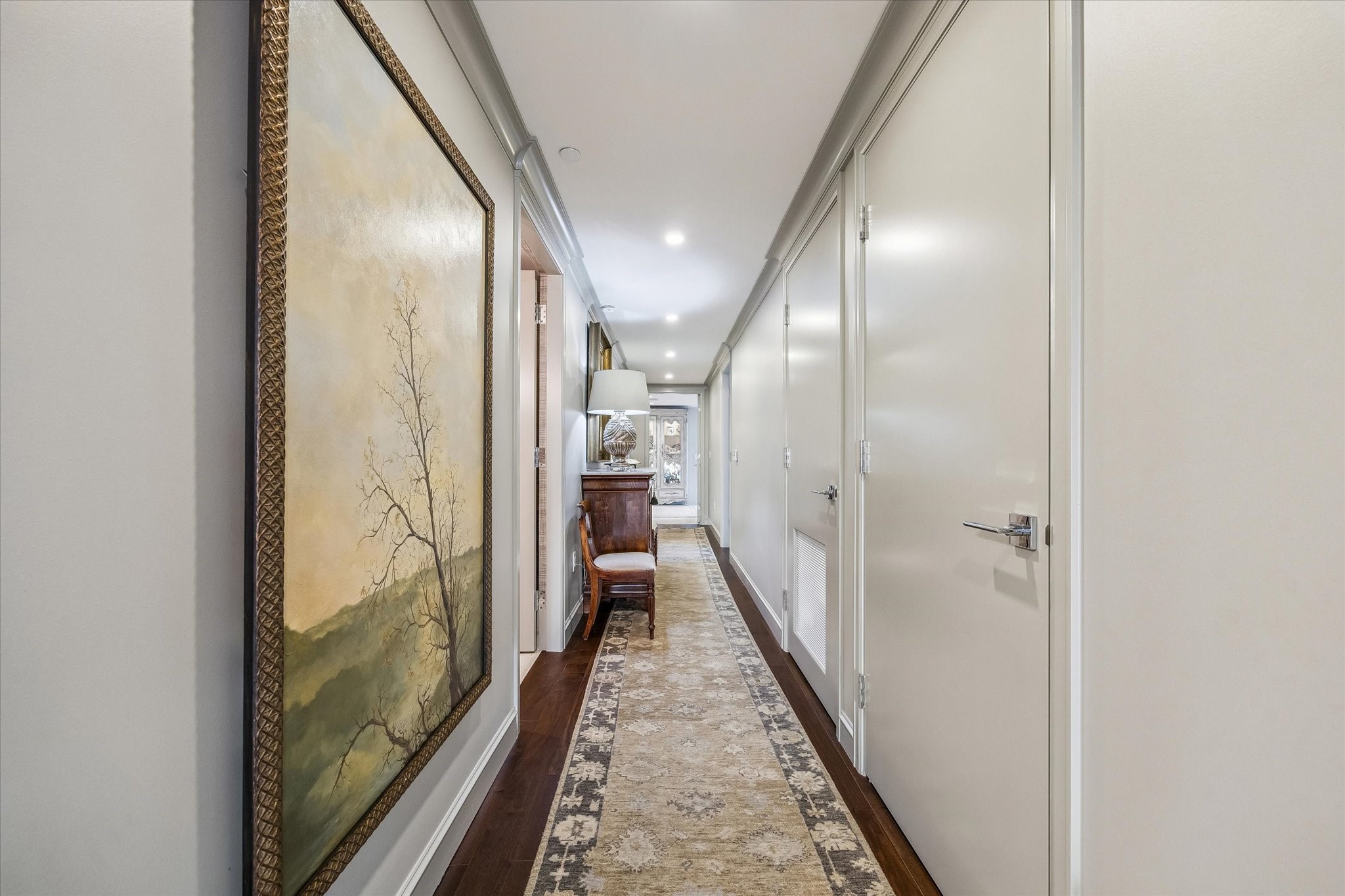3433 Westheimer Road, Unit 706 Houston, TX 77027 - Photo 15 of 41 a view of a hallway with wooden floor and a bathroom