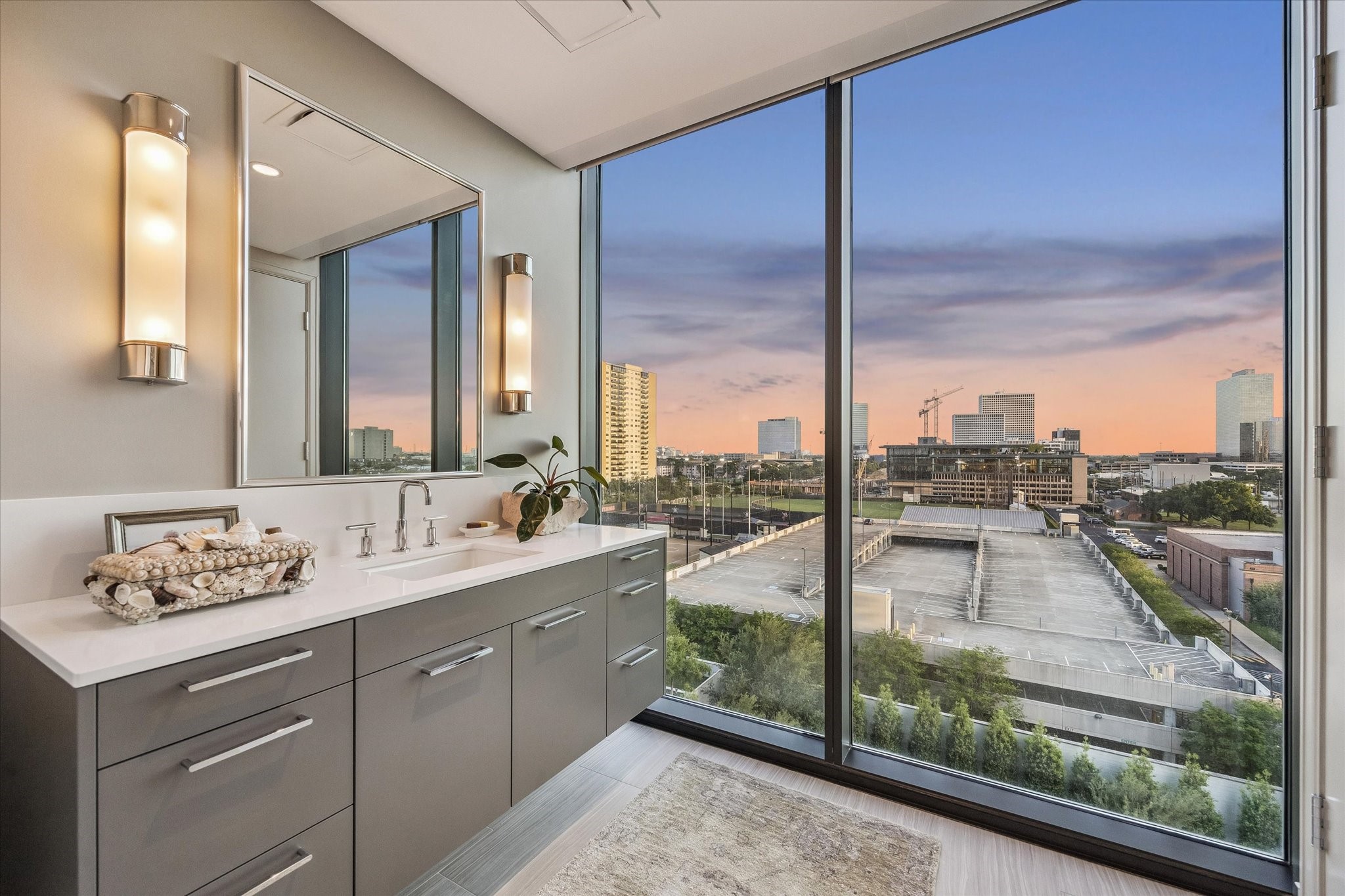 3433 Westheimer Road, Unit 706 Houston, TX 77027 - Photo 19 of 41 a bathroom with a double vanity sink and mirror