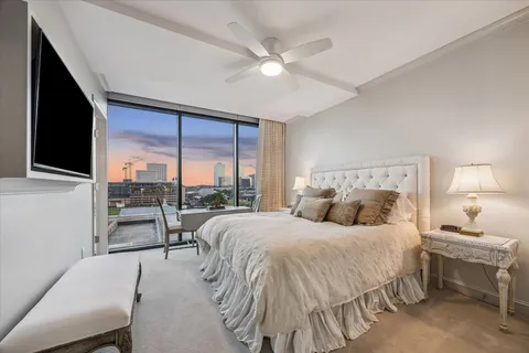 a bedroom with a large bed and a large window