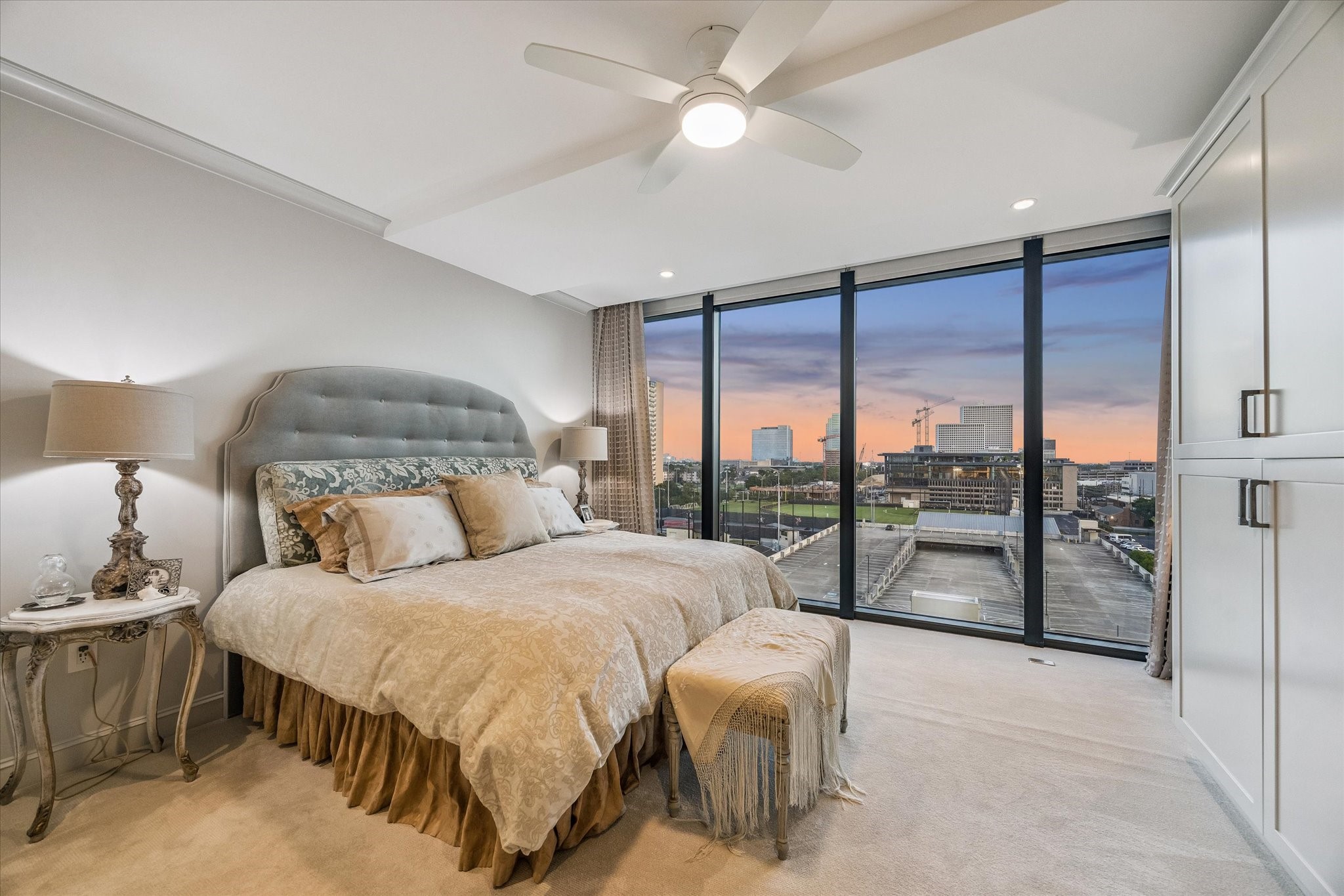 3433 Westheimer Road, Unit 706 Houston, TX 77027 - Photo 26 of 41 a bedroom with a large bed and a chandelier fan