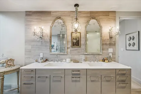a bathroom with a double vanity sink mirror and