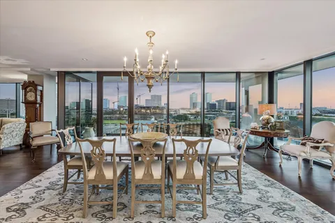 a view of a dining room with furniture large windows and wooden floor