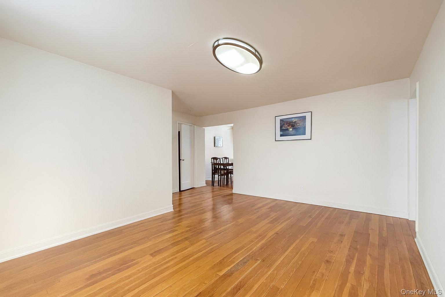 7 Terrace Circle, Unit 3D Great Neck, NY 11021 - Photo 5 of 31 a view of empty room with wooden floor