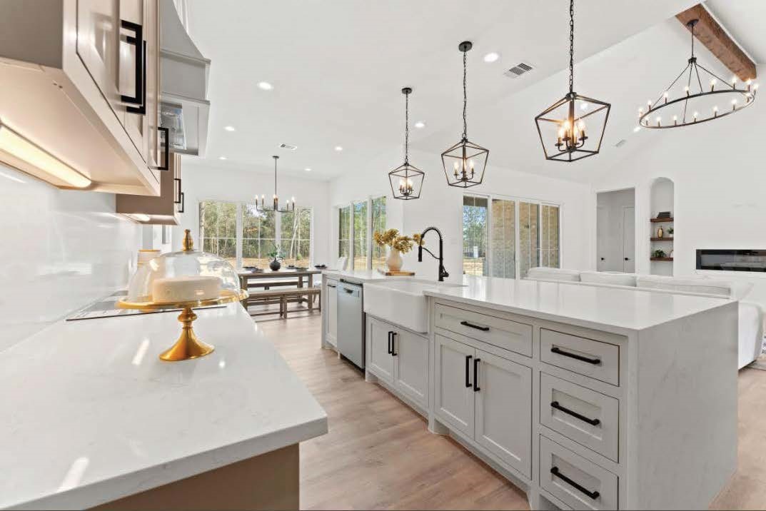 15045 Tybee Lane Conroe, TX 77306 - Photo 13 of 41 a large kitchen with stainless steel appliances lots of counter space and a chandelier