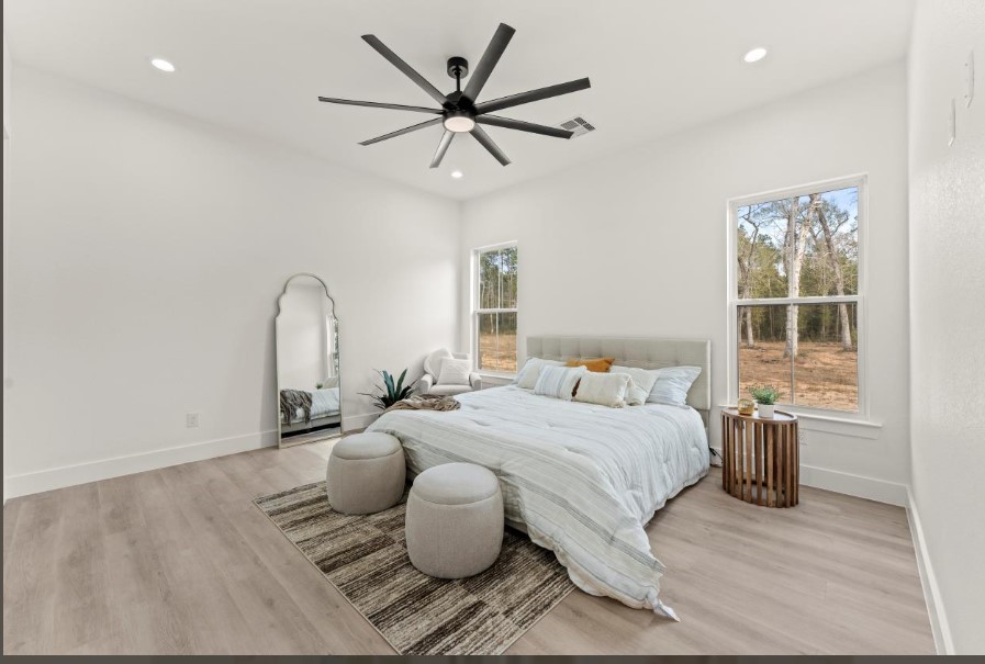 15045 Tybee Lane Conroe, TX 77306 - Photo 19 of 41 a bedroom with a bed and ceiling fan