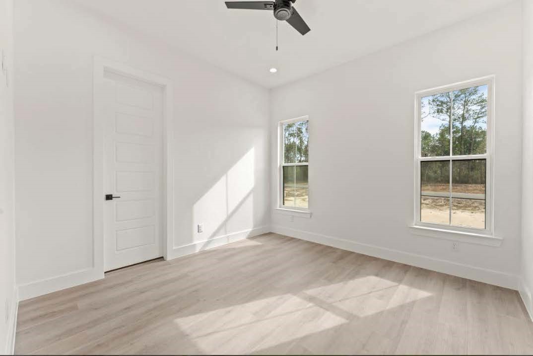 15045 Tybee Lane Conroe, TX 77306 - Photo 21 of 41 an empty room with windows and closet