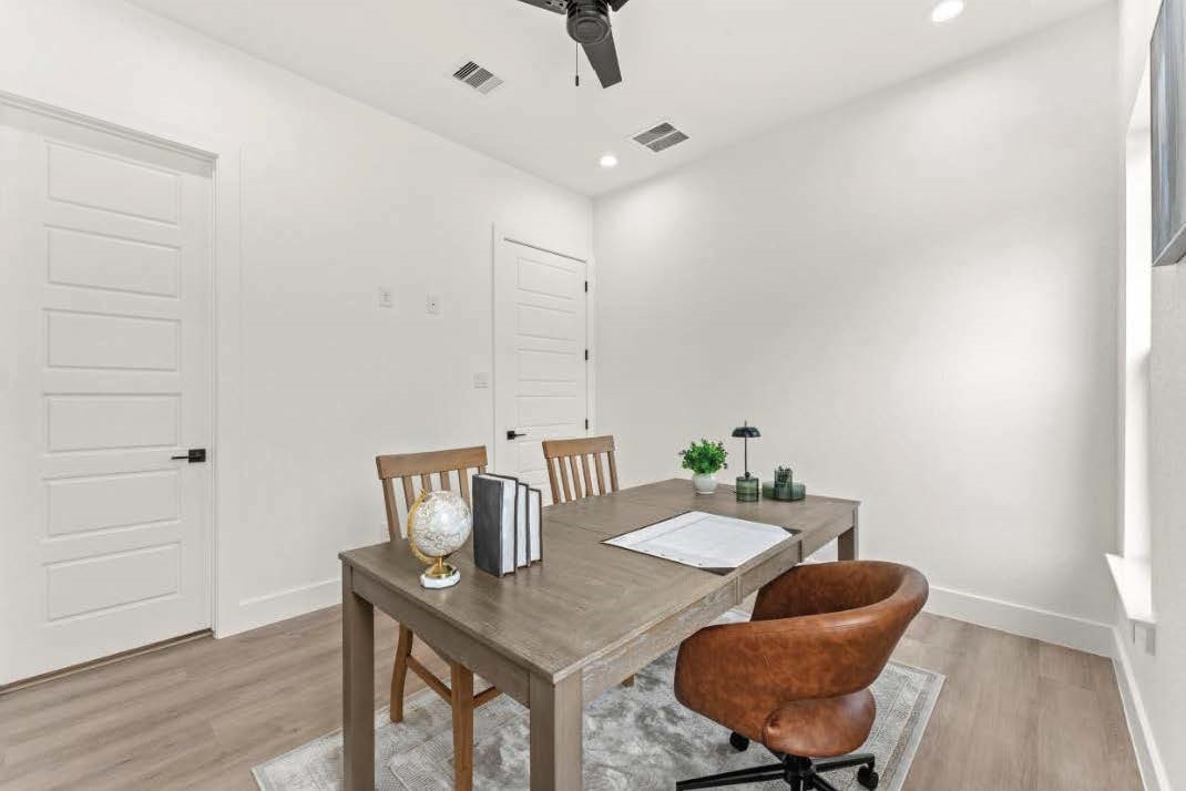 15045 Tybee Lane Conroe, TX 77306 - Photo 23 of 41 a view of a dining room with furniture and wooden floor