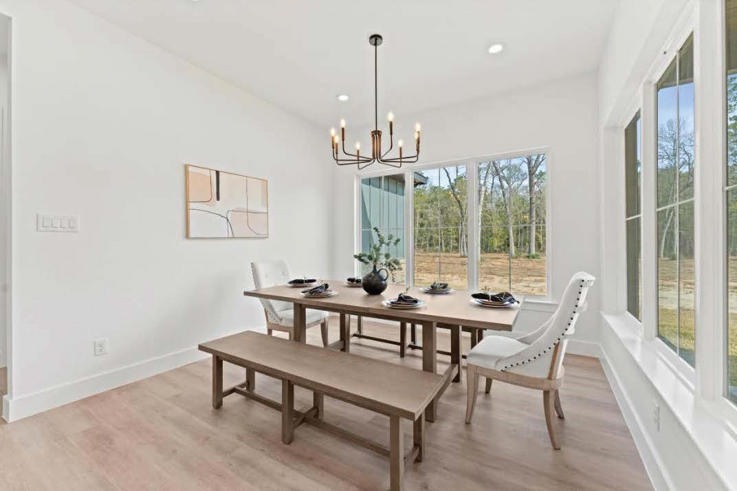 15045 Tybee Lane Conroe, TX 77306 - Photo 29 of 41 a view of a dining room with furniture window and wooden floor