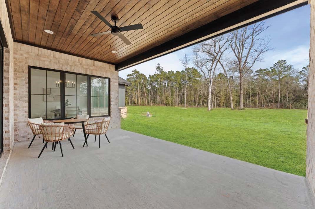 15045 Tybee Lane Conroe, TX 77306 - Photo 6 of 41 a patio with a yard table and chairs