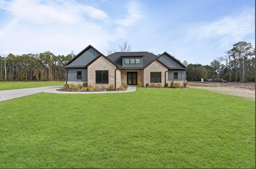 15045 Tybee Lane Conroe, TX 77306 - Photo 7 of 41 a front view of a house with a garden and trees