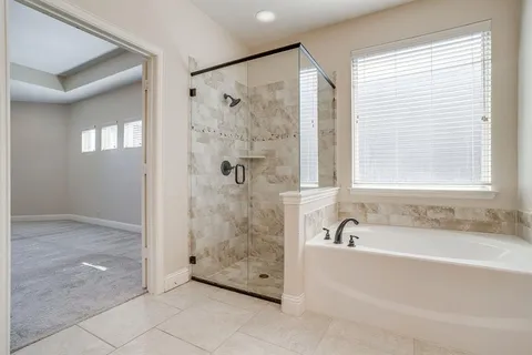 a bathroom with a bathtub and shower