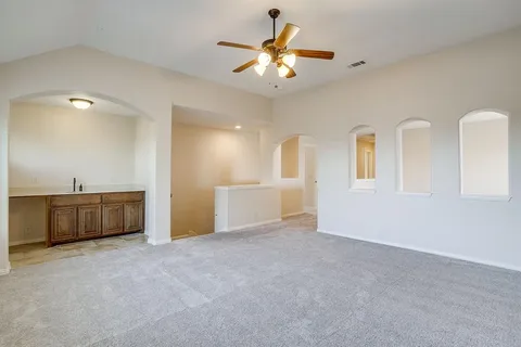 a view of an empty room with a ceiling fan