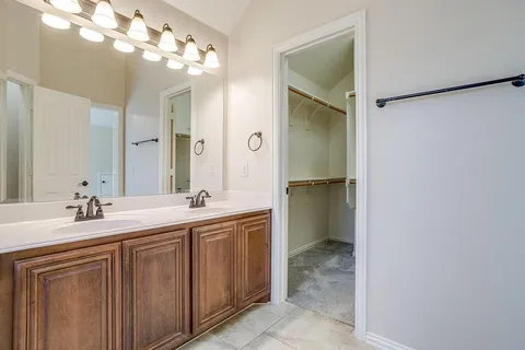a bathroom with a double vanity sink and a mirror