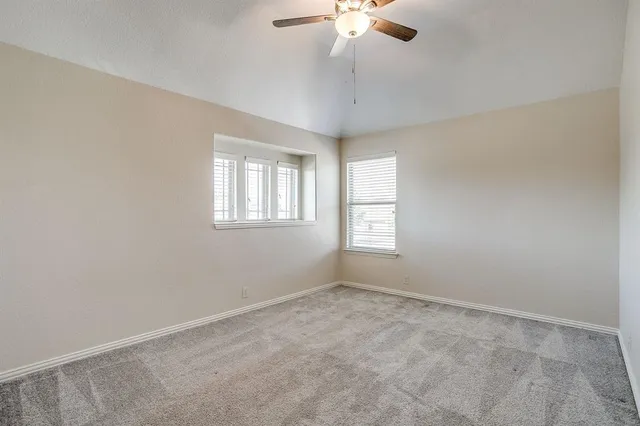 an empty room with projector and cabinets