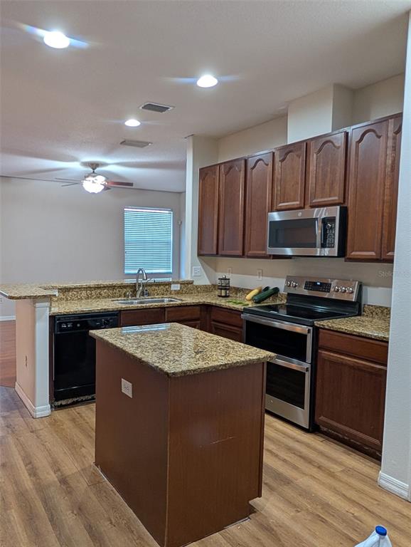 7524 Dragon Fly Loop Gibsonton, FL 33534 - Photo 11 of 55 a kitchen with stainless steel appliances granite countertop a stove a sink and a microwave