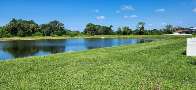 a view of a lake with a yard and lake