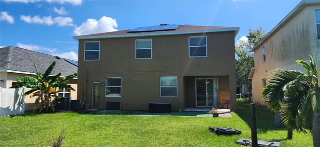 a view of a house with a backyard