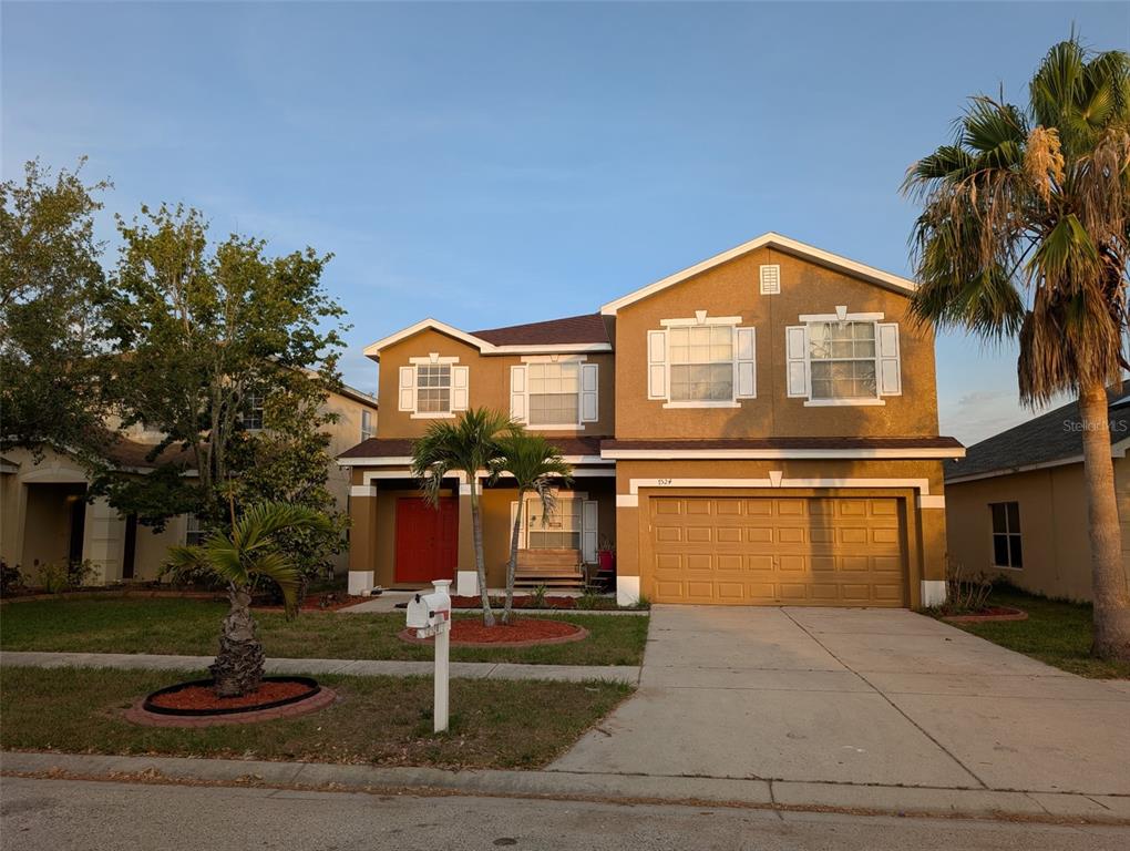 7524 Dragon Fly Loop Gibsonton, FL 33534 - Photo 2 of 55 a front view of a house with a garden and tree