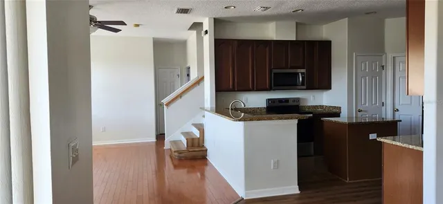 a kitchen with a refrigerator stove and microwave