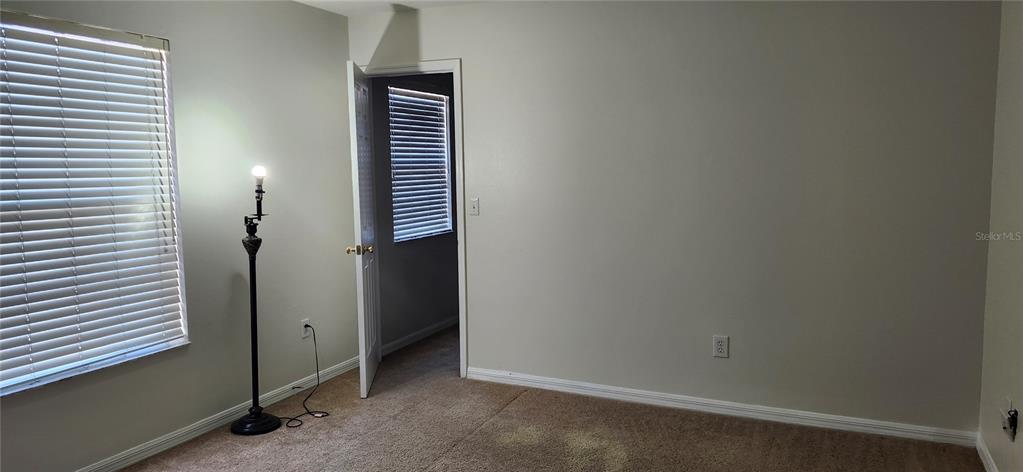 7524 Dragon Fly Loop Gibsonton, FL 33534 - Photo 30 of 55 an empty room with wooden floor and a window