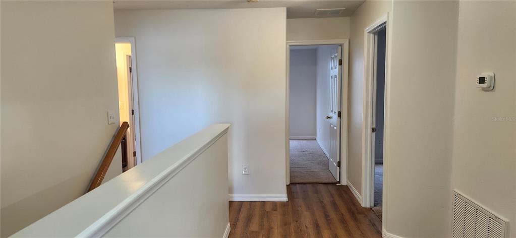 7524 Dragon Fly Loop Gibsonton, FL 33534 - Photo 44 of 55 a view of a hallway with wooden floor and entryway