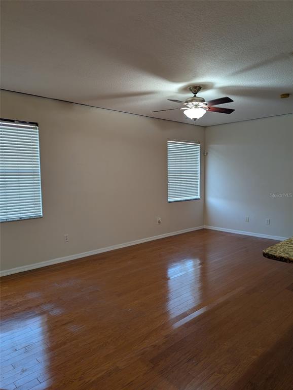 7524 Dragon Fly Loop Gibsonton, FL 33534 - Photo 5 of 55 a view of an empty room with wooden floor and a window