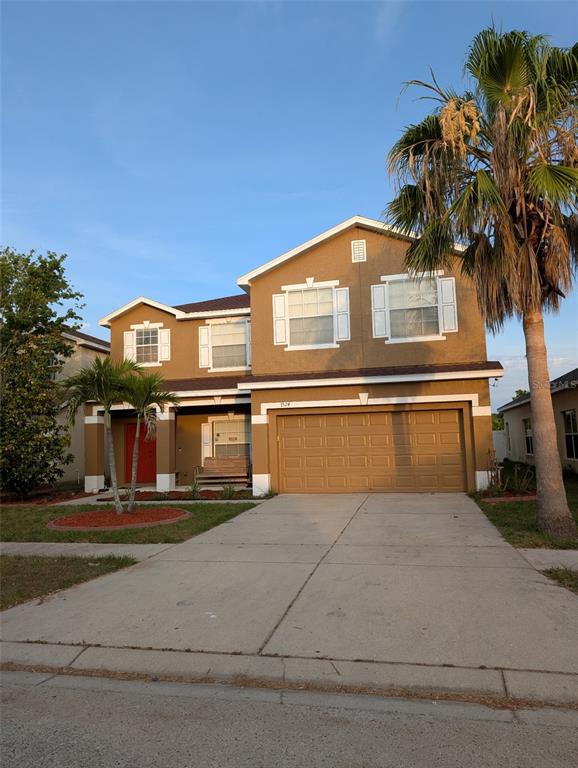 7524 Dragon Fly Loop Gibsonton, FL 33534 - Photo 9 of 55 a front view of a house with a garden