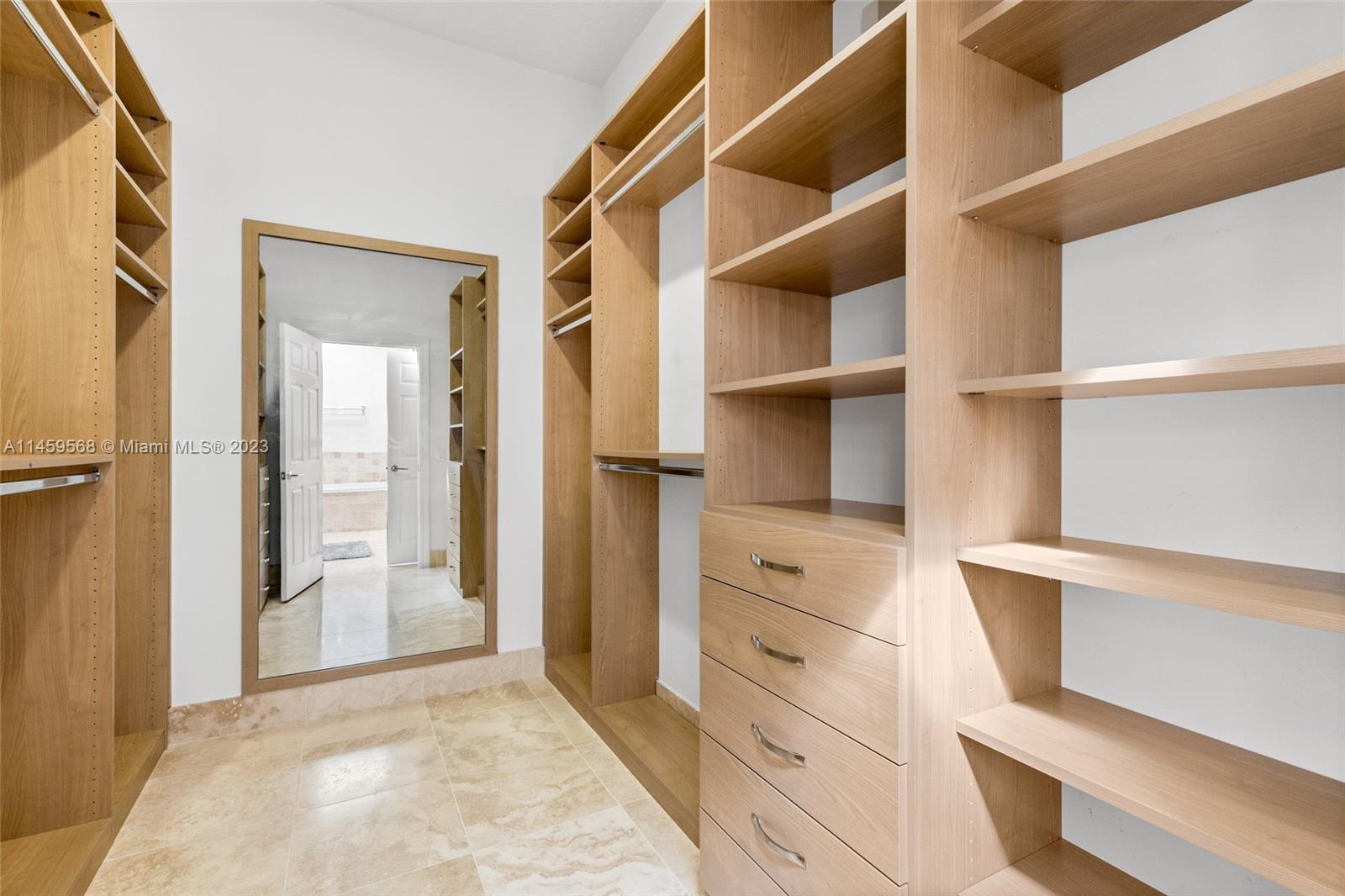 5675 Regency Circle West Boca Raton, FL 33496 - Photo 22 of 74 a view of walk in closet with empty racks