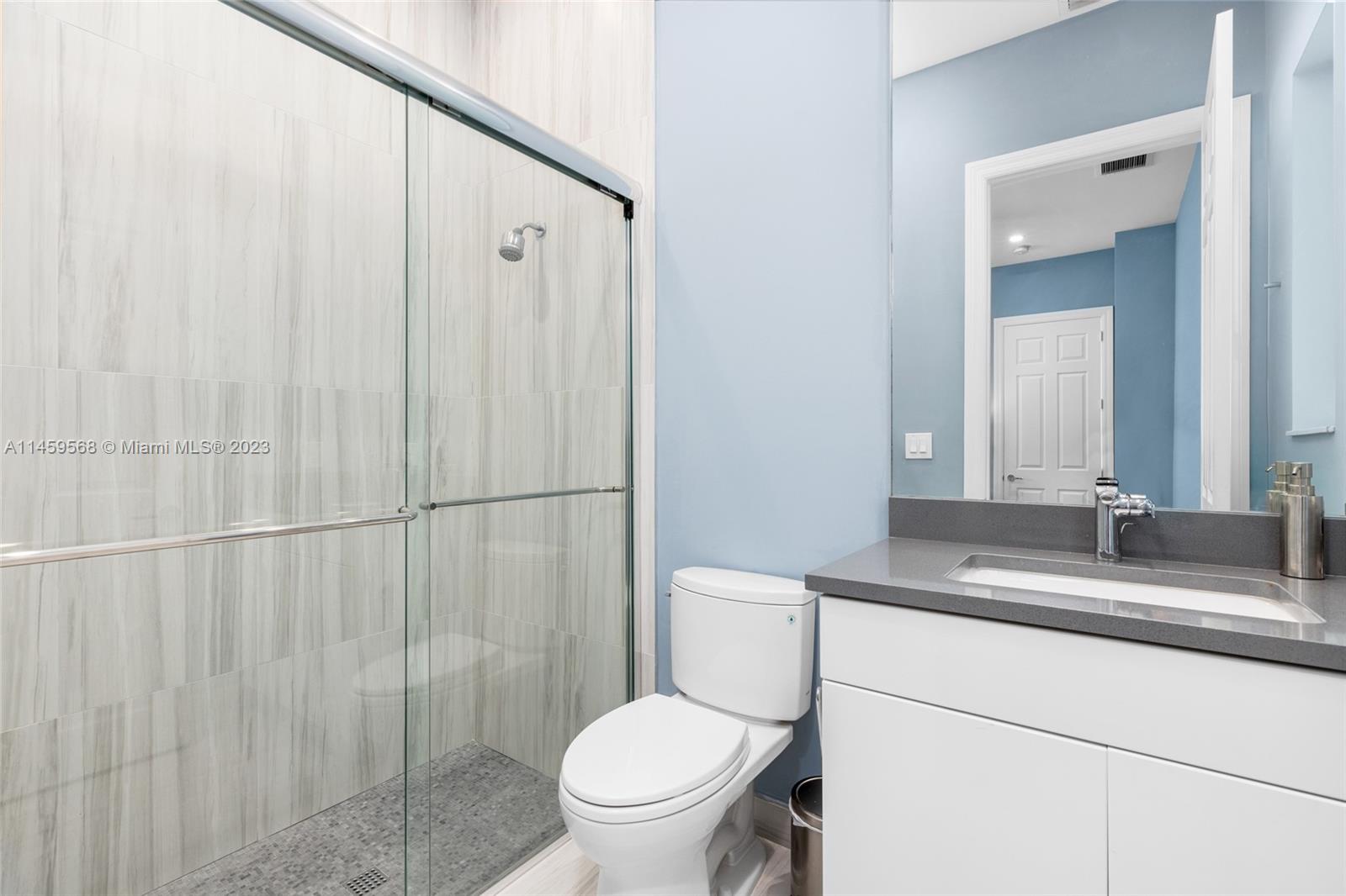 5675 Regency Circle West Boca Raton, FL 33496 - Photo 25 of 74 a bathroom with a granite countertop sink toilet and shower