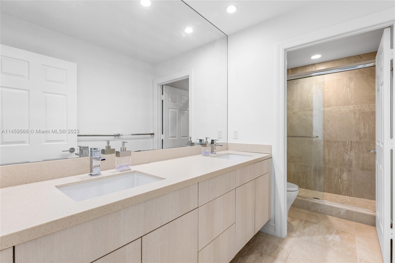 5675 Regency Circle West Boca Raton, FL 33496 - Photo 28 of 74 a bathroom with a double vanity sink mirror and shower