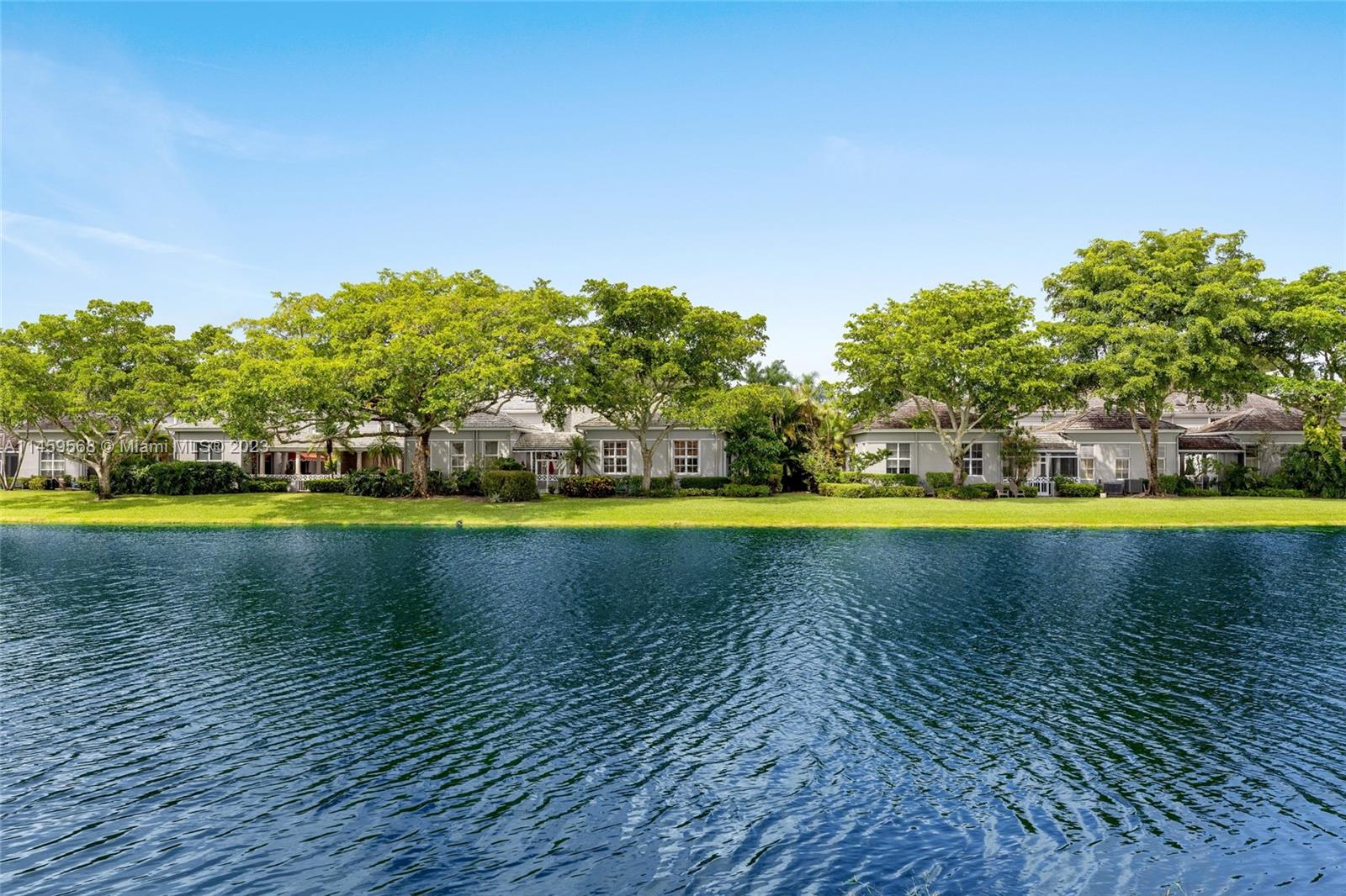 5675 Regency Circle West Boca Raton, FL 33496 - Photo 39 of 74 a view of a swimming pool and trees in the background