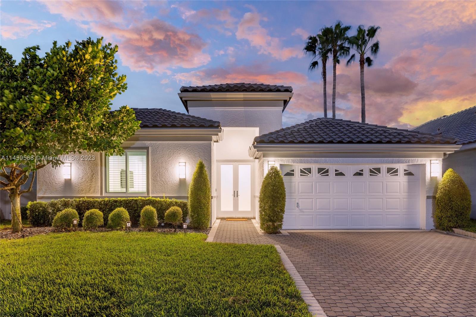 5675 Regency Circle West Boca Raton, FL 33496 - Photo 41 of 74 a front view of a house with a garden