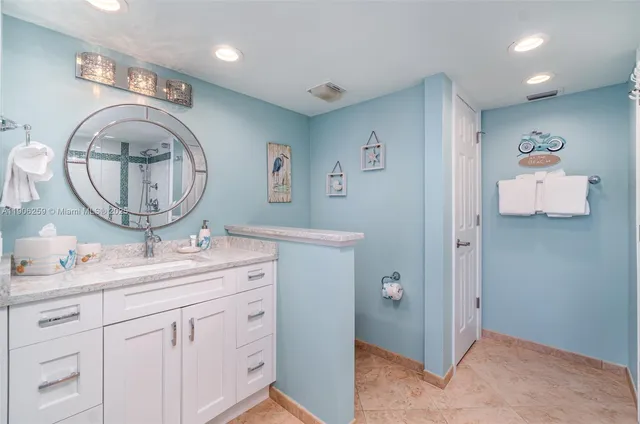 a bathroom with a double vanity sink mirror and toilet