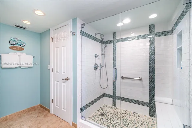 a bathroom with a shower and a sink