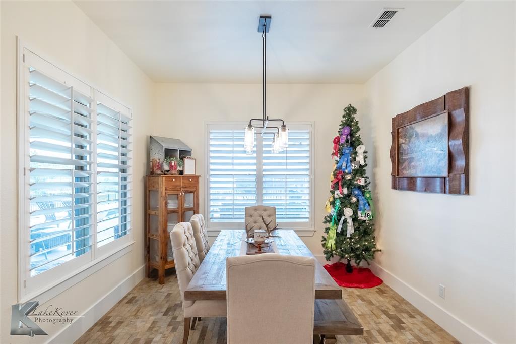 622 Ranch Road Buffalo Gap, TX 79508 - Photo 15 of 40 a dining room with furniture window and wooden floor