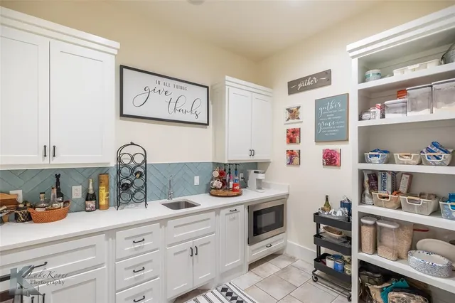 a kitchen with a refrigerator and cabinets