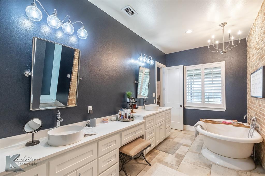 622 Ranch Road Buffalo Gap, TX 79508 - Photo 18 of 40 a bathroom with a double vanity sink mirror and toilet