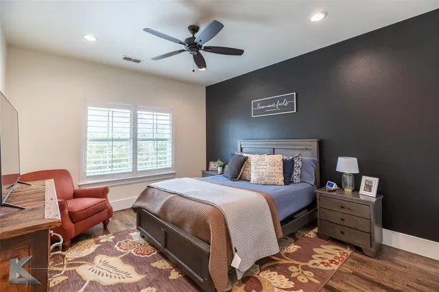 a bedroom with a bed and a chair