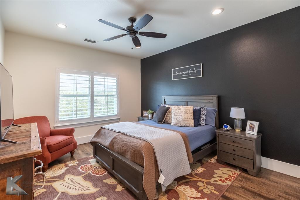622 Ranch Road Buffalo Gap, TX 79508 - Photo 31 of 40 a bedroom with a bed and a chair