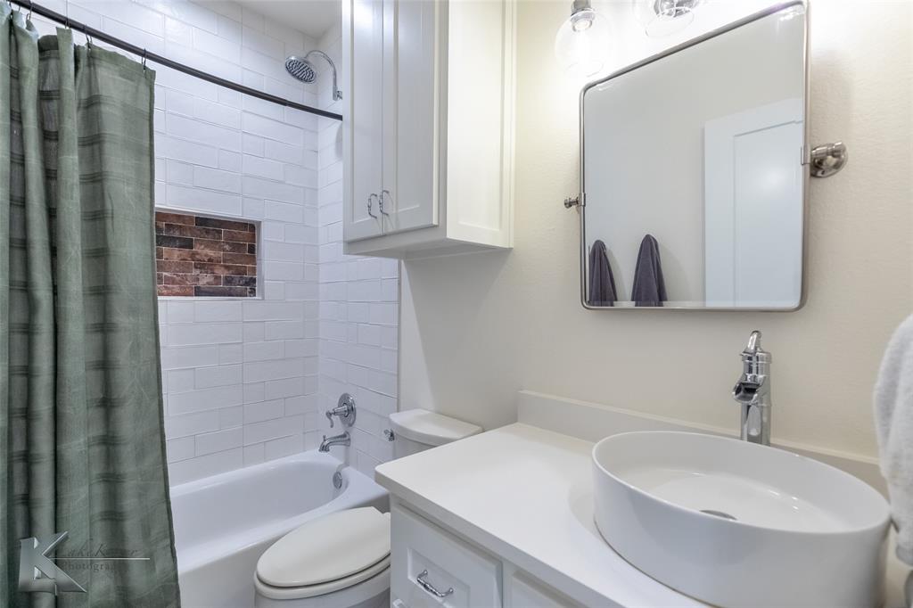 622 Ranch Road Buffalo Gap, TX 79508 - Photo 32 of 40 a bathroom with a sink toilet and shower