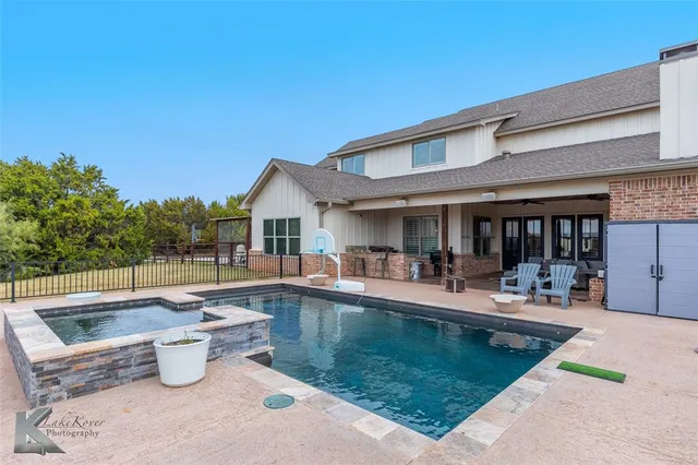 a view of living room with furniture and large windows