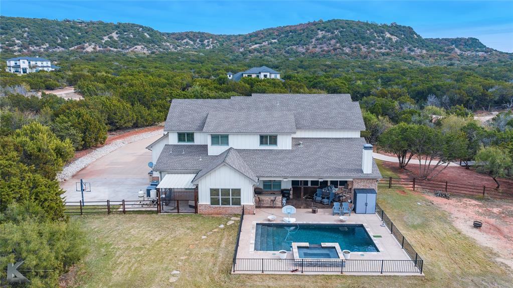 622 Ranch Road Buffalo Gap, TX 79508 - Photo 40 of 40 an aerial view of a house with swimming pool and mountains