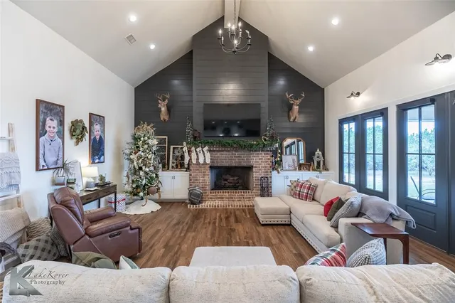 a living room with furniture a fireplace and a flat screen tv