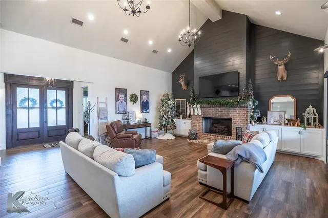 a living room with furniture a fireplace and a flat screen tv