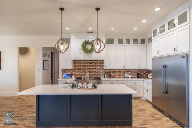 a kitchen with a sink stainless steel appliances and cabinets