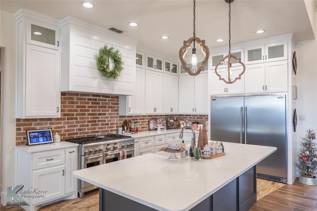 622 Ranch Road Buffalo Gap, TX 79508 - Photo 10 of 40 a kitchen with kitchen island a counter space a sink appliances and cabinets