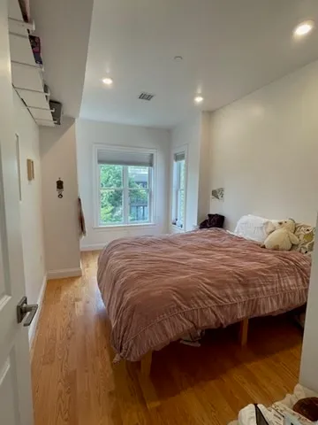 a bedroom with a bed and a window