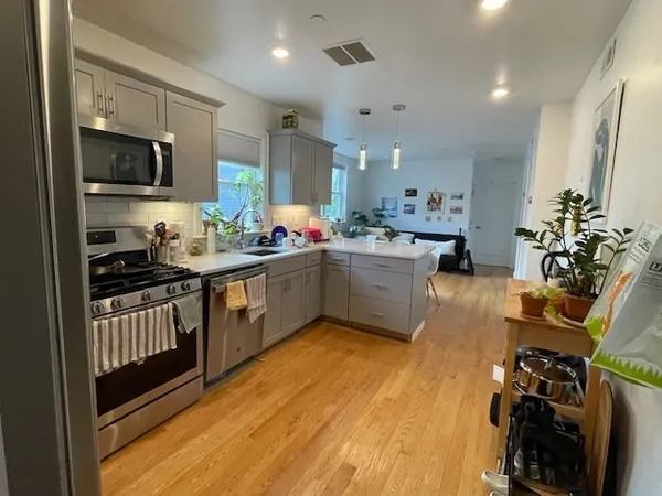 a kitchen with a sink appliances and cabinets