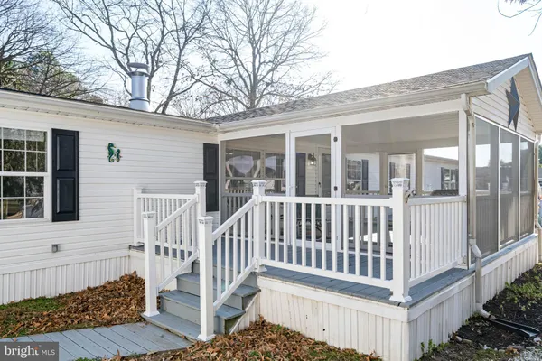 a view of a house with a yard and deck